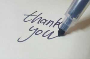 pen writing the words thank you