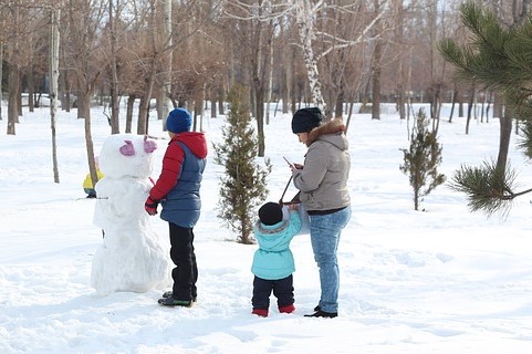 family building a snowman