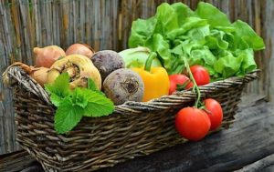 Wicker basket filled with fresh garden vegetables