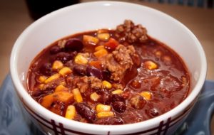 Bowl of chili with tomato sauce, beans, corn and meat
