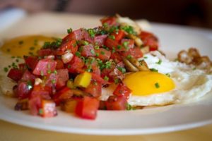 Fried egg topped with fresh salsa