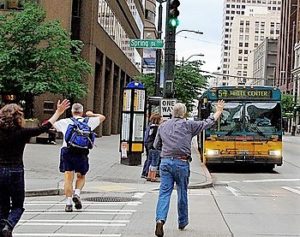 people running to catch a bus