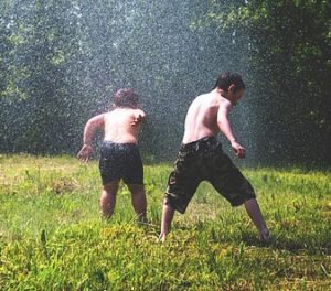 boys in sprinkler
