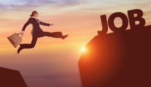 Women in business suit jumping from one rock to another labeled JOB.