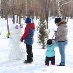 family building a snowman