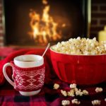 Fireplace with popcorn and hot beverage
