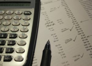 calculator, pencil, list of expenses