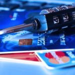 a combination lock on top of a pile of credit cards