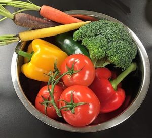 Stainless steel bowl filled with fresh garden vegetables