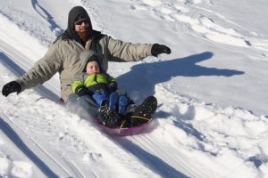 Father and child Sledding