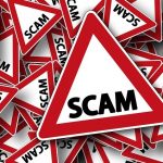 Triangle warning sign with word SCAM