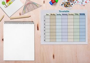Schedule, paper, pencils to create a weekly schedule