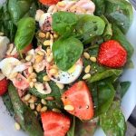Strawberry and spinach salad with mushrooms, pine nuts and hard boiled eggs