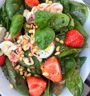 Strawberry and spinach salad with mushrooms, pine nuts and hard boiled eggs