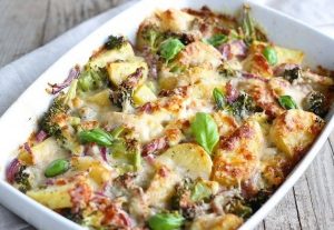 Casserole dish including potatoes, broccoli, red onions, basil, turkey and white sauce