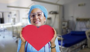 Nurse holding a red heart