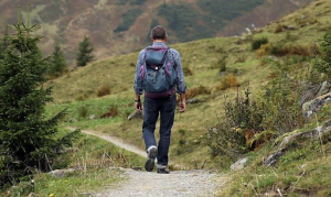 man hiking down trail 
