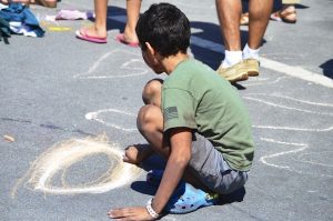 boy drawing with chalk