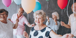 Older adults celebrating with balloons