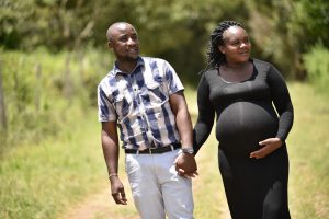 pregnant women walking and holding hands with a man