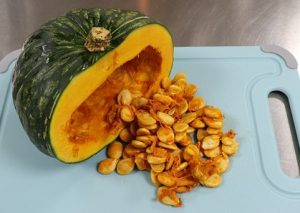 pumpkin cut in half with seeds spilling out
