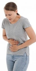 Women in pain holding stomach