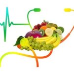 Several pieces of high fiber fruit, stethoscope and heartbeat line