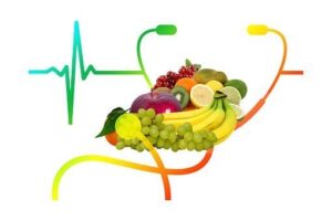 several pieces of fruit, stethoscope and heartbeat line