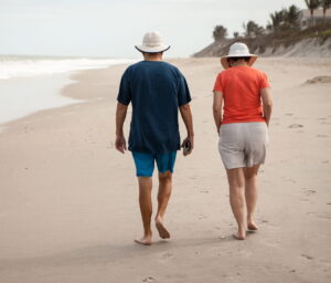 Retired couple walking on a beach