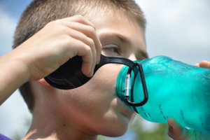 child drinking from a reusable water bottle