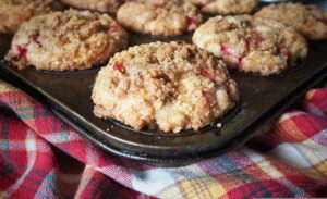 cranberry muffins with strudel topping in a muffin pan