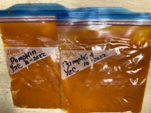 two labeled freezer bags, each containing 1/2 pumpkin puree