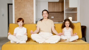 Family of three meditating