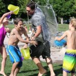 kids playing with water in a park