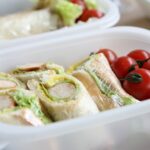 lunch box with sandwich and cherry tomatoes