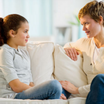 Parent visiting with child on a couch
