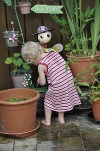 small child with potted plants