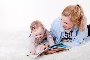 Mother reading to baby girl
