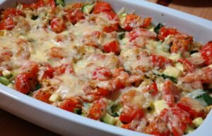 Casserole containing noodles, zucchini, tomatoes and cheese