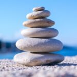 Stack of balanced rocks with blue sky in the back ground.