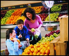 Mother and children shopping for fruit