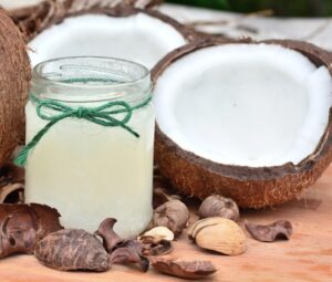 jar of coconut oil and a coconut split in half