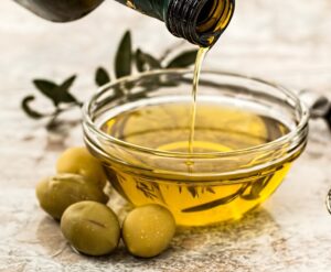 Olive oil being poured into a small bowl