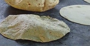 flatbread cooking and puffing up on a griddle