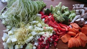 Raw chopped carrots, mushrooms, broccoli, red bell peppers, celery, cabbage, and diced hot peppers.