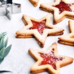 Star shaped cookies filed with red raspberry and apricot jam