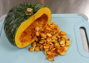 Pumpkin cut in half with seeds spilling out