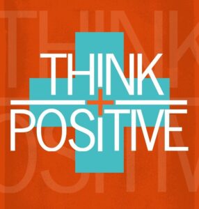 photo of words think + positive on an orange background with a large teal plus sign