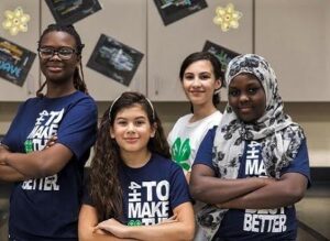 Four youth in 4-H t-shirts. 